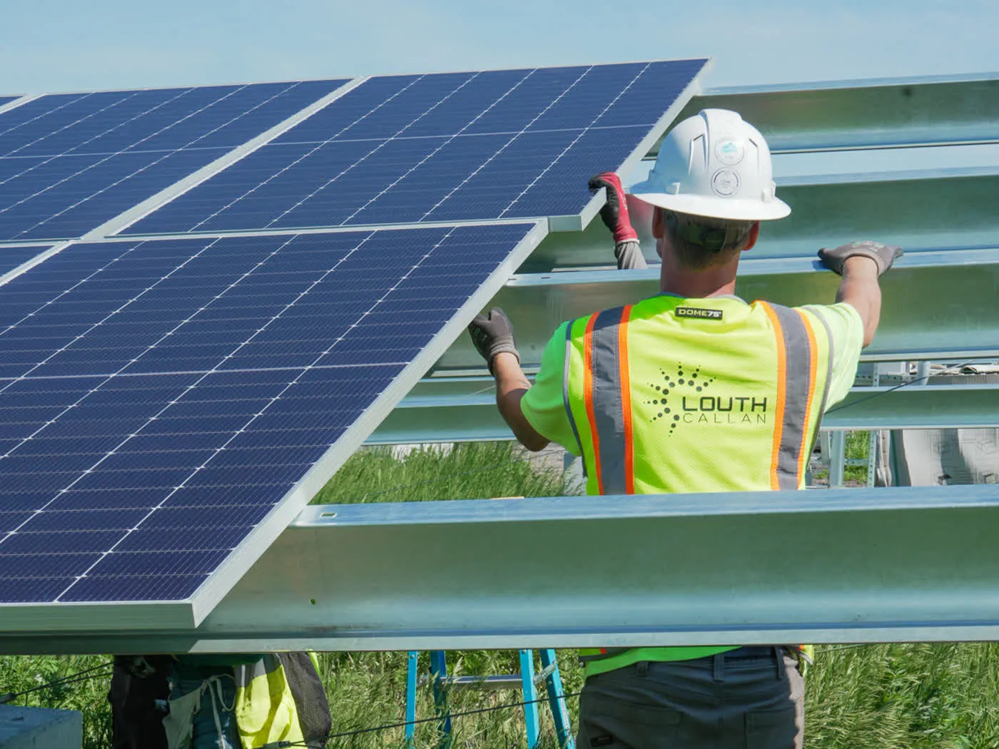 A Louth Callan crew member in full personal protective equipment working on an array.