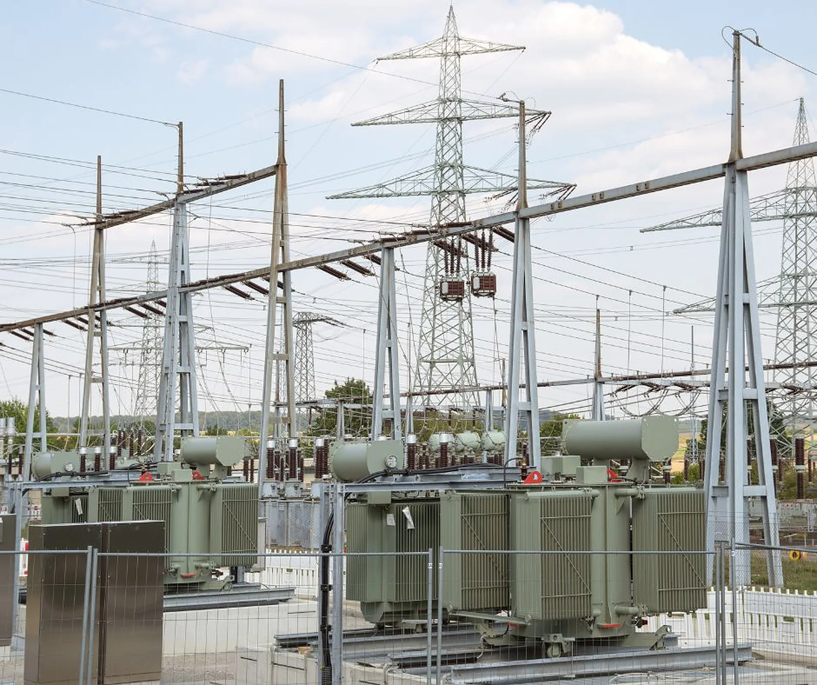 A collector substation yard with transformers, gantries and overhead bus.